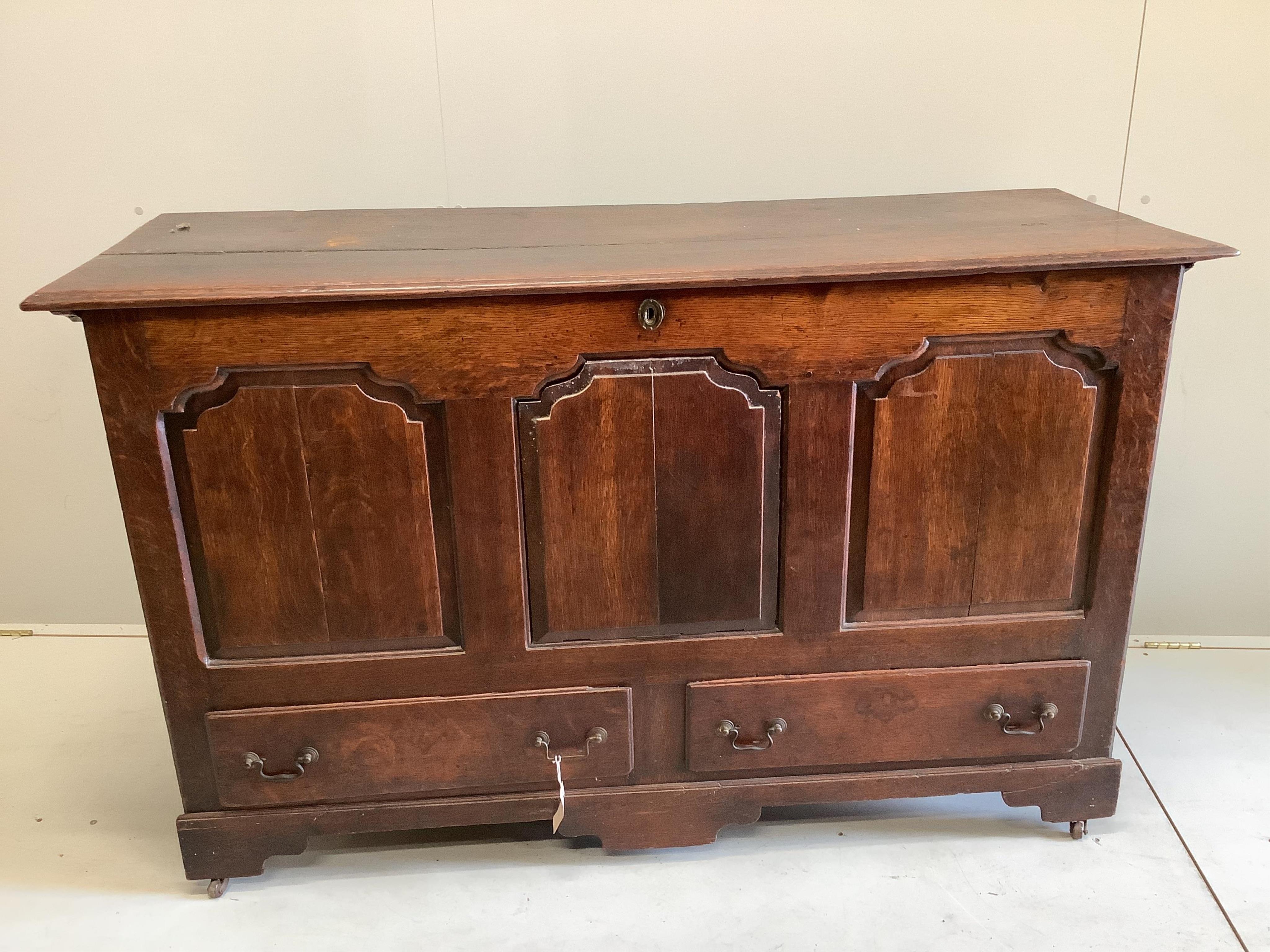 An 18th century panelled oak mule chest, adapted, width 152cm, depth 54cm, height 92cm. Condition - fair